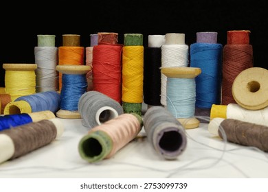 Multicolored spools thread. Spools of multi-colored threads lies on the table
