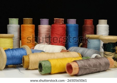 Multicolored spools thread. Spools of multi-colored threads lies on white table, close-up shot photo