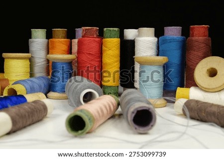 Multicolored spools thread. Spools of multi-colored threads lies on the table
