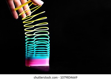 Multi-colored spring with a black background.
