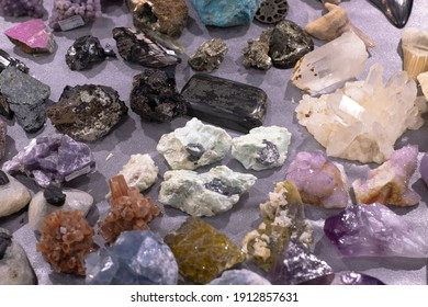 multi-colored stones and minerals lie on the table in daylight. Exhibition of stones, exclusive, sale, trade, selection. Fair, Good Buy, Mining