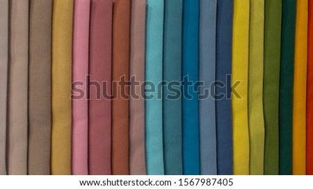 Multi-colored strips of fabric, samples of textile material. Soft fleecy fleece, a palette of color shades. Backdrop wallpaper background