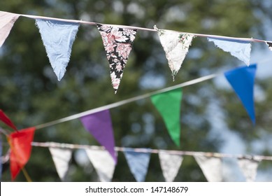 Multicolored Summer Bunting Flags Hanging At An English Garden Party Fete.