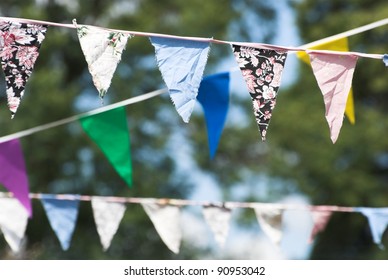 Multicolored Summer Bunting Flags Hanging At An English Garden Party Fete.