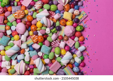 Multicolored sweet and bright dragee, candies, lollipops, marshmallows for fun party on pink background - Powered by Shutterstock