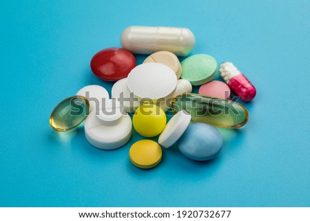 Multicolored tablets on blue background. Health care concept