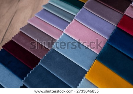 Multicolored textile samples forming clean fabric background for fashion and interior design