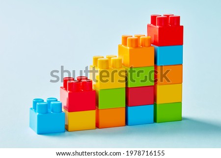 Multi-colored toy blocks chart on blue