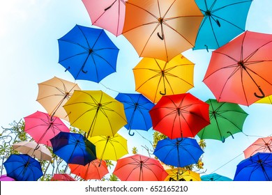 Multi-colored umbrellas background. Colorful umbrellas floating above the street. Street decoration. - Powered by Shutterstock