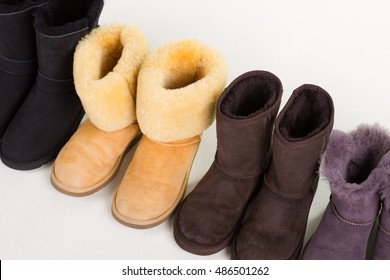 Multicolored winter boots on a white background. Warm Australian shoes. Women's fashion boots.