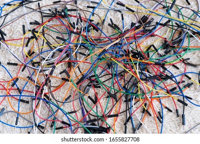 Multi-colored wires for assembling and connecting electronic lie on a bright table.