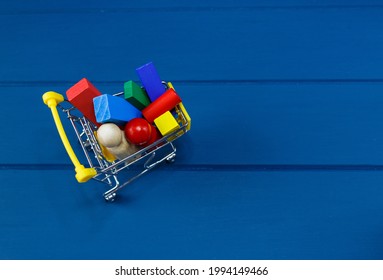 Multicolored Wooden Blocks, Cars, Train In Basket On Blue Background. Trendy Eco-friendly Puzzle Toys. Educational Toys For Kindergarten, Preschool. Back To School. Online Shopping For School.