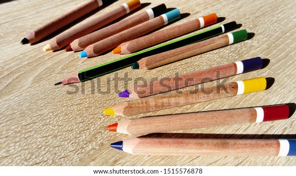 Multicolored wooden pencils for drawing. Pencils\
for working out the correct position of the pen in the fingers.\
Help first grader. The development of fine motor skills of the\
fingers