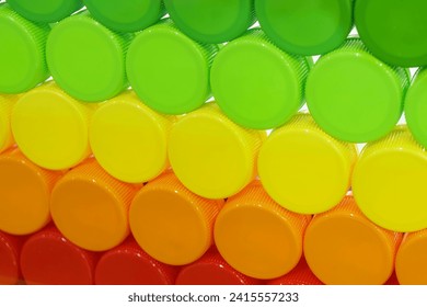 Multi-colors background of plastic drinking water caps. The plastic caps manufacturing concept.