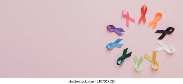 Multicolour ribbons on pink background, cancer awareness, World cancer day, world autism awareness day