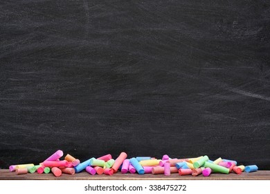 Multicoloured chalk on blackboard background - Powered by Shutterstock