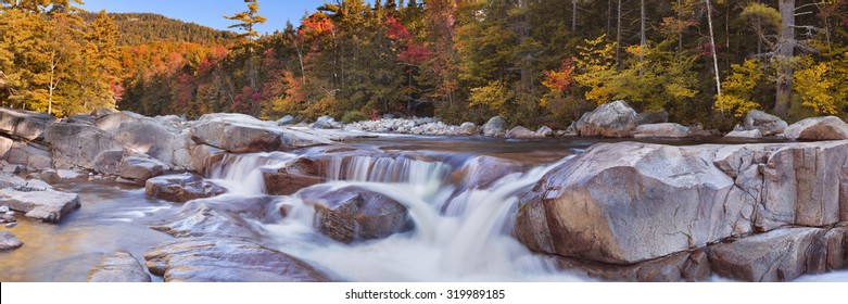Multi-coloured Fall Foliage Along The Swift River Lower Falls, White Mountain National Forest In New Hampshire, USA.