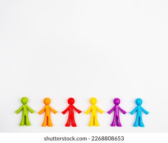 Multicoloured figurines of men on a light-coloured background . Concept of family, society, non-traditional relationships. - Shutterstock ID 2268808653