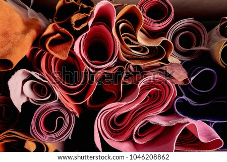 Multicoloured leather in rolls on the shelf in a shop for hand crafting or hand made. Natural material, ecological