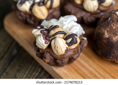 multicomponent cake made of caramel and nuts in chocolate, mixed hazelnut cake with almonds and caramel - Shutterstock ID 2174078213