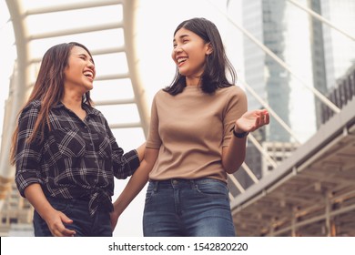 Multicultural Asian girlfriends, having fun talking together on holiday vacation - Millenial lifestyle with female best friends women - Friendship concept with happy, laughing girls at summer city