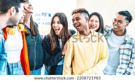 Multicultural best friends having fun hanging out together - Happy young people laughing walking on city street - International students talking outside school in college campus - Friendship concept