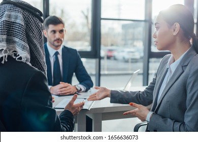 multicultural business partners talking on meeting with translator in office