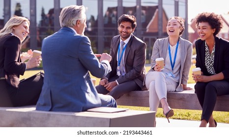 Multi-Cultural Business Team Sitting Outside Office For Coffee Break Have Informal Meeting - Powered by Shutterstock