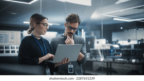 Multicultural Chief Technology Officer Talking to Software Developer, Discussing Neural Network Updates in High Tech Research and Development Facility. Professional Computer Specialists at Work