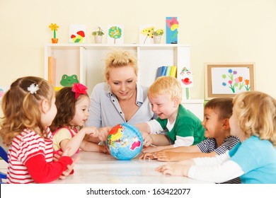 Multicultural childrens hands on a globe