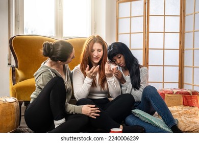 Multicultural comforting female friends come to aid of their sad best friend at home - Friendship relationship concept between multiethnic female friends helping together and supporting each other - Powered by Shutterstock