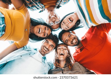 Multicultural community of young people smiling at camera outside - International university students taking selfie picture together - Friendship concept with guys and girls having fun on city street - Powered by Shutterstock