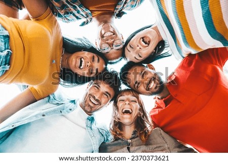 Multicultural community of young people smiling at camera outside - International university students taking selfie picture together - Friendship concept with guys and girls having fun on city street