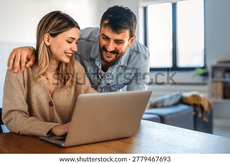Multicultural couple working remotely, planning finances and investments online. Digital lifestyle