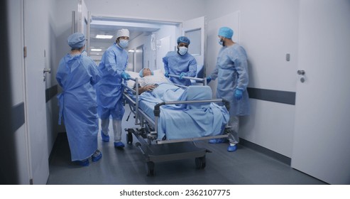 Multicultural doctors transport senior patient to operating room down clinic center hallway. Medics open doors to surgery for colleagues. Elderly man lies on gurney under drip and with pulse oximeter. - Powered by Shutterstock