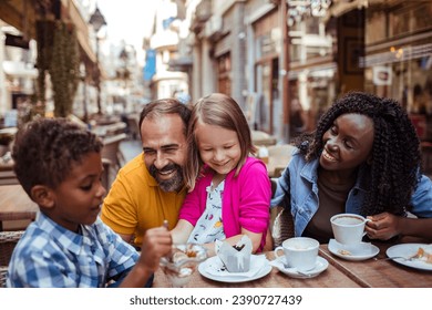 Multicultural Family Enjoying Desserts at an Outdoor Cafe - Powered by Shutterstock