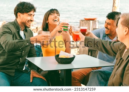Multicultural Friends Brining with Colorful Cocktails by the Seaside
