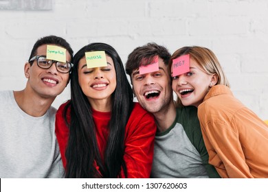 multicultural friends with funny nickname labels on foreheads