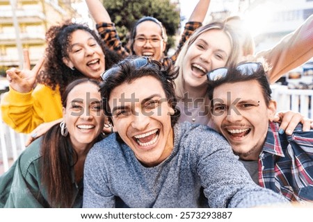Multicultural friends smiling at camera together outside - Happy young people taking selfie with smart mobile phone device walking on city street - Youth community and technology concept
