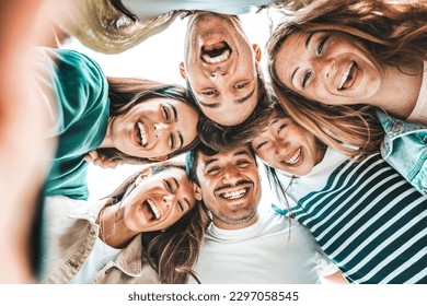 Multicultural friends taking selfie pic with smartphone outside - Happy young people smiling at camera together - Youth community concept with guys and girls hugging outdoors  - Shutterstock ID 2297058545