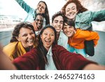 Multicultural friends taking selfie with smart mobile phone outside - Happy young people smiling together at camera - Technology and youth culture concept