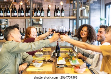 Multicultural Friends Toasting Red Wine At Sushi Bar Restaurant - Bright Vivid Filter With Focus On Black Woman On Right