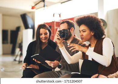 Multicultural Group Of Attendees Sitting In Studio And Taking Photos On Photography Class.