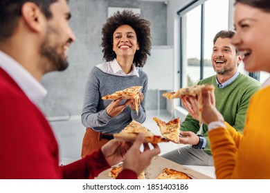 Multicultural group of business people having lunch in corporate firm and eating pizza. - Powered by Shutterstock