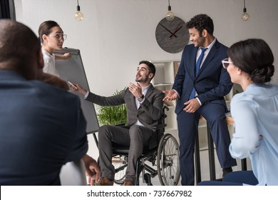 multicultural group of businesspeople discussing business strategy - Powered by Shutterstock