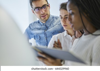 Multicultural Group Of Creative Journalists Planning Working Strategy While Talking With Each Other During Collaborating, Male And Female Professionals Creating Business Startup Project In Office