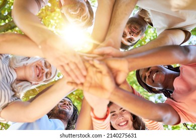 Multicultural Group Of Friends Stacks Hands As A Team For Motivation In Summer In Nature