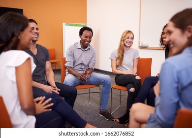 Multi-Cultural Group Of Men And Women At Mental Health Group Therapy Meeting