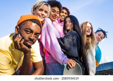 Multicultural group of young friends bonding outdoors and having fun - Stylish cool teens gathering at urban skate park - Shutterstock ID 2085934519