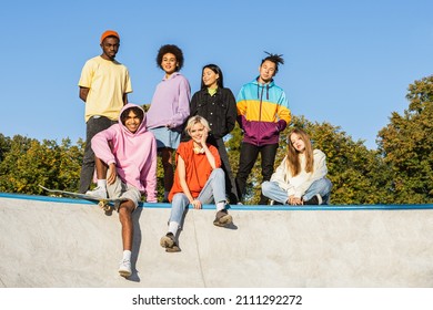 Multicultural Group Of Young Friends Bonding Outdoors And Having Fun - Stylish Cool Teens Gathering At Urban Skate Park